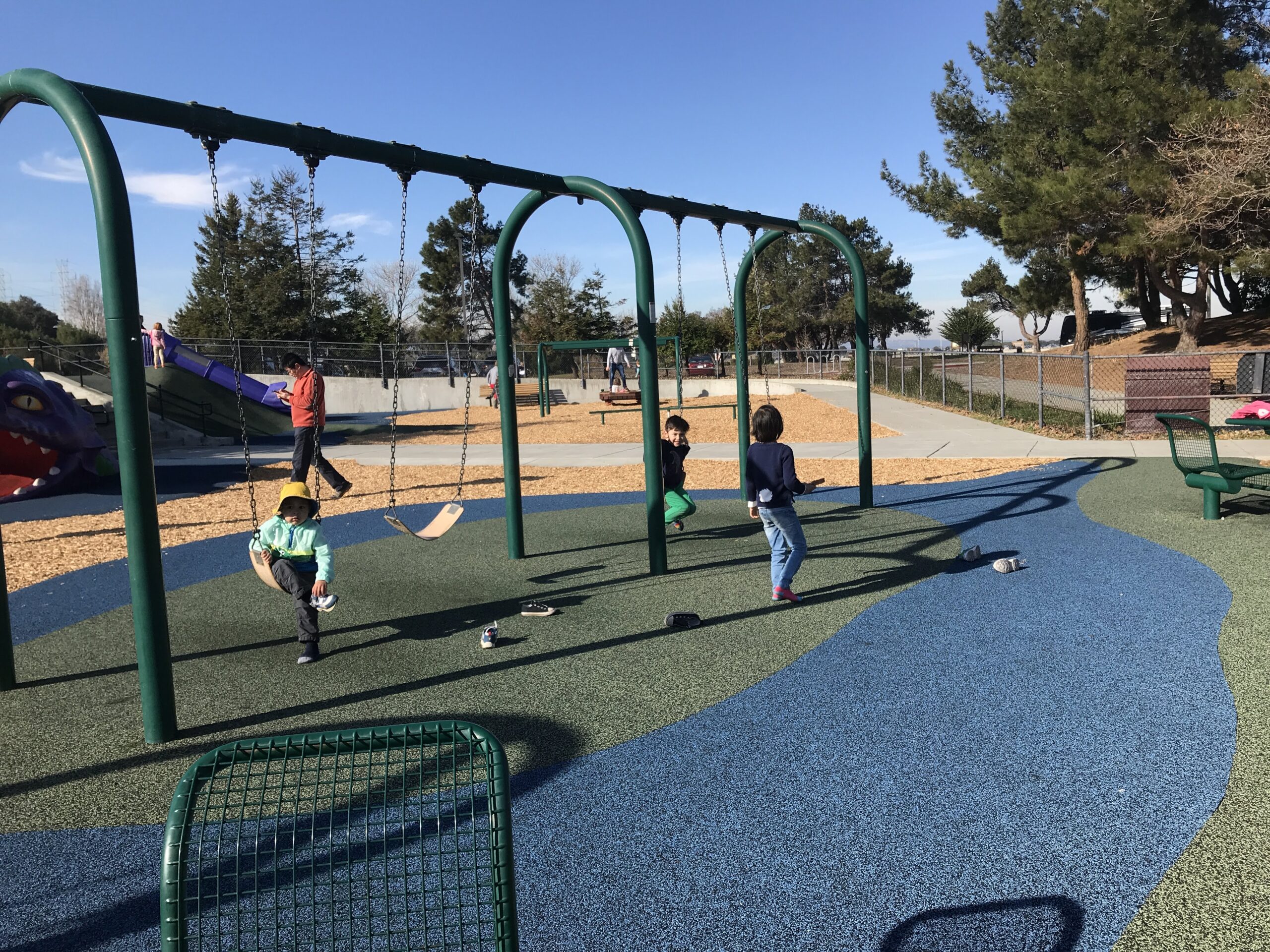 kids on a swingset at a playground